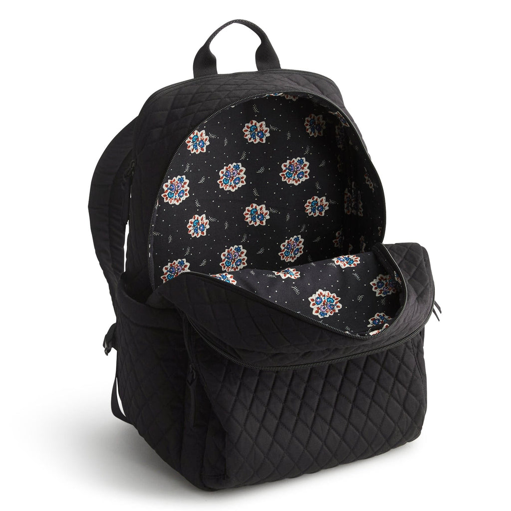 Black quilted backpack with floral pattern interior on a white background