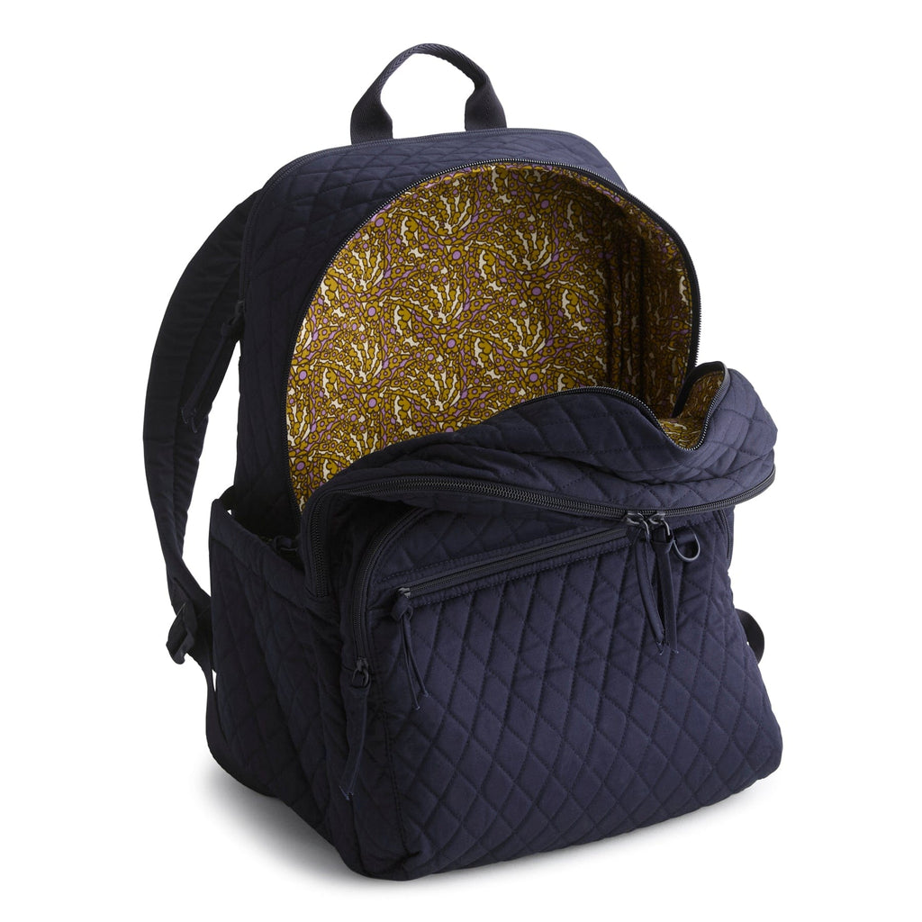 Navy blue quilted backpack with gold interior lining on a white background