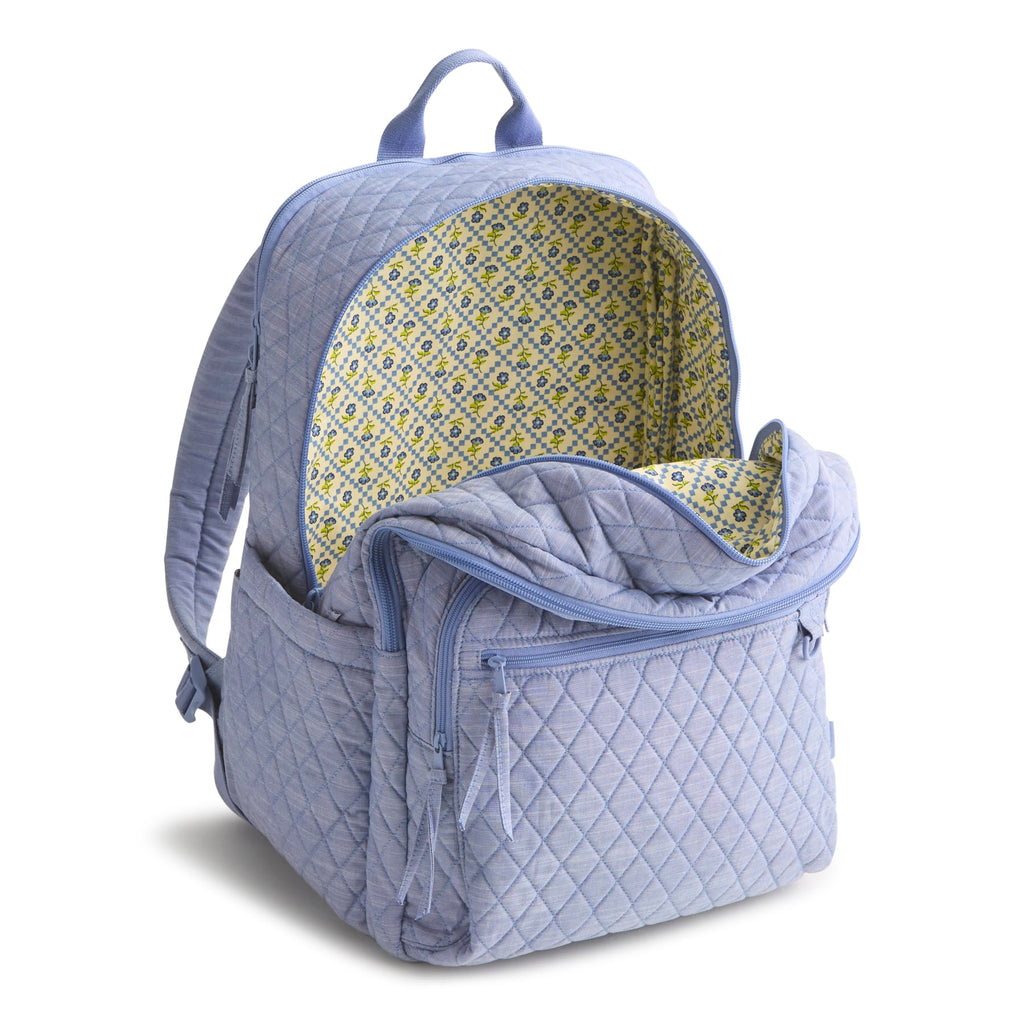 Quilted blue backpack with floral interior on a white background