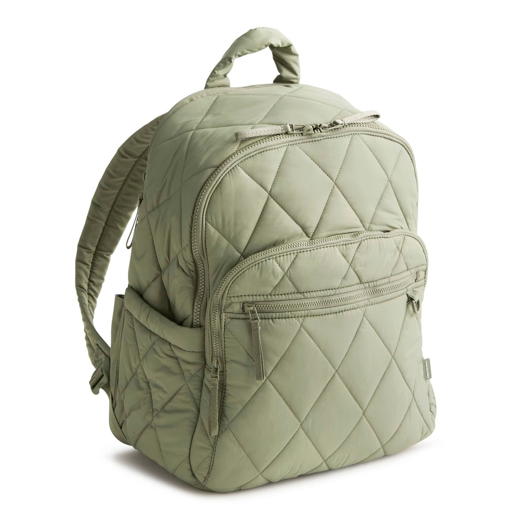 Green quilted backpack on a white background