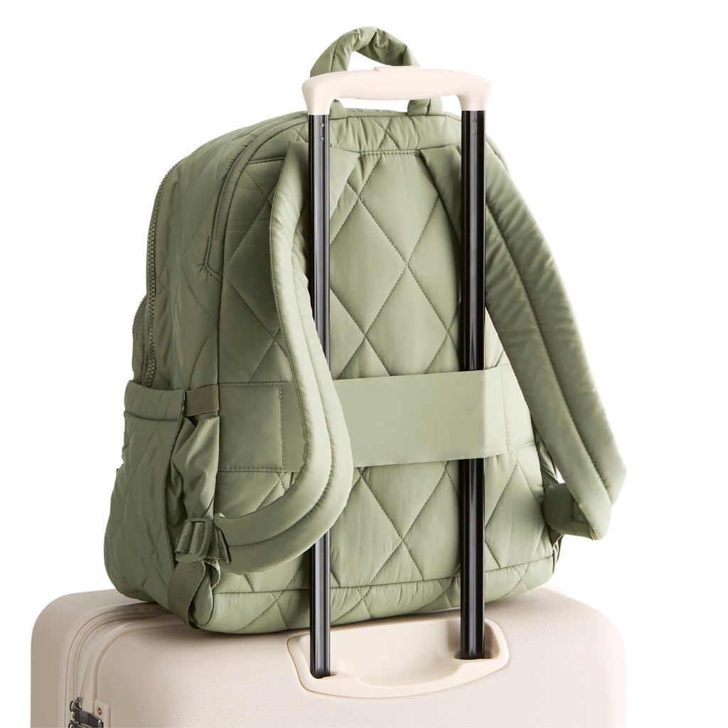 Green quilted backpack with rolling handle on a white background