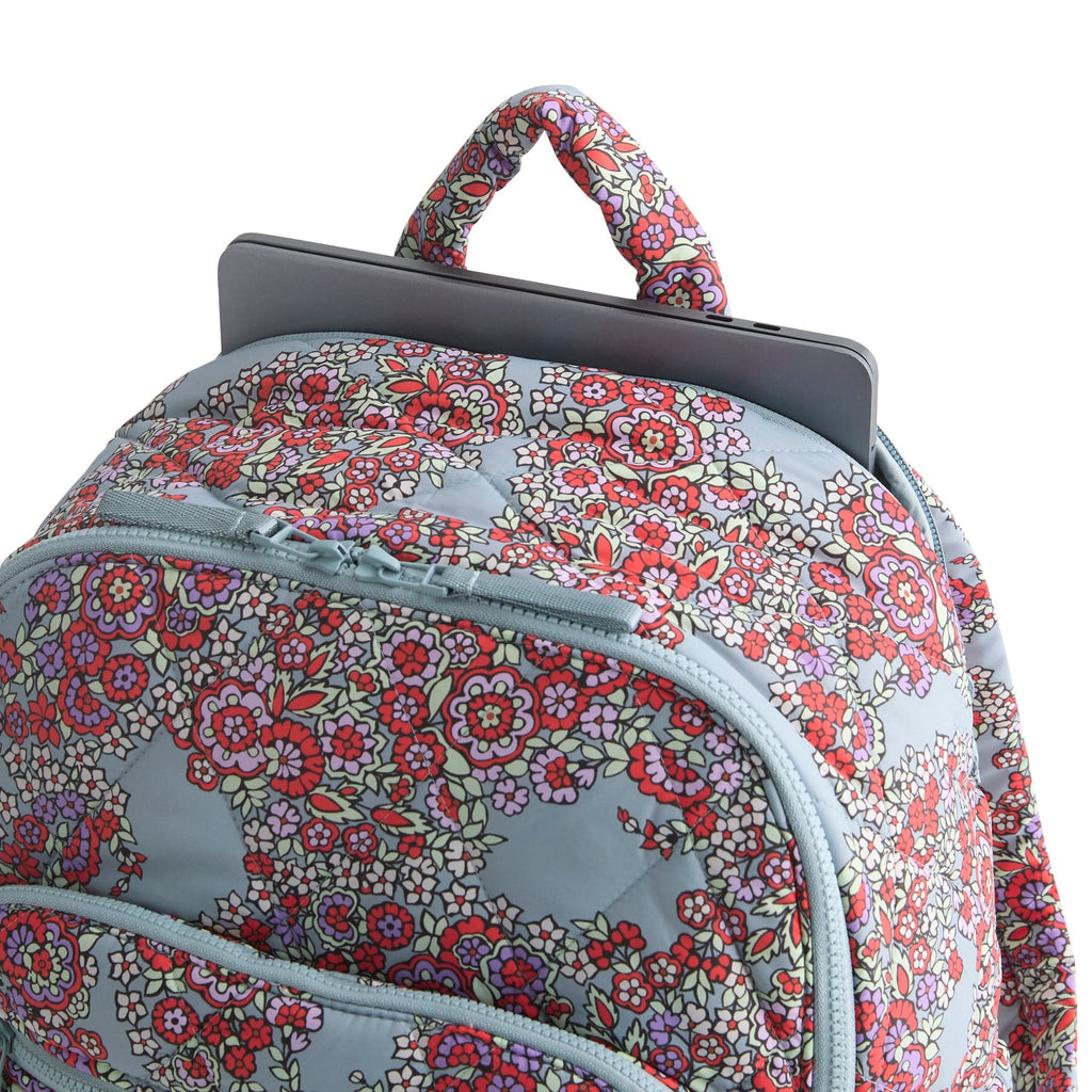 Floral patterned backpack with a laptop compartment on a white background