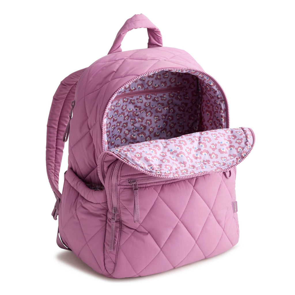 Purple quilted backpack with floral interior on a white background