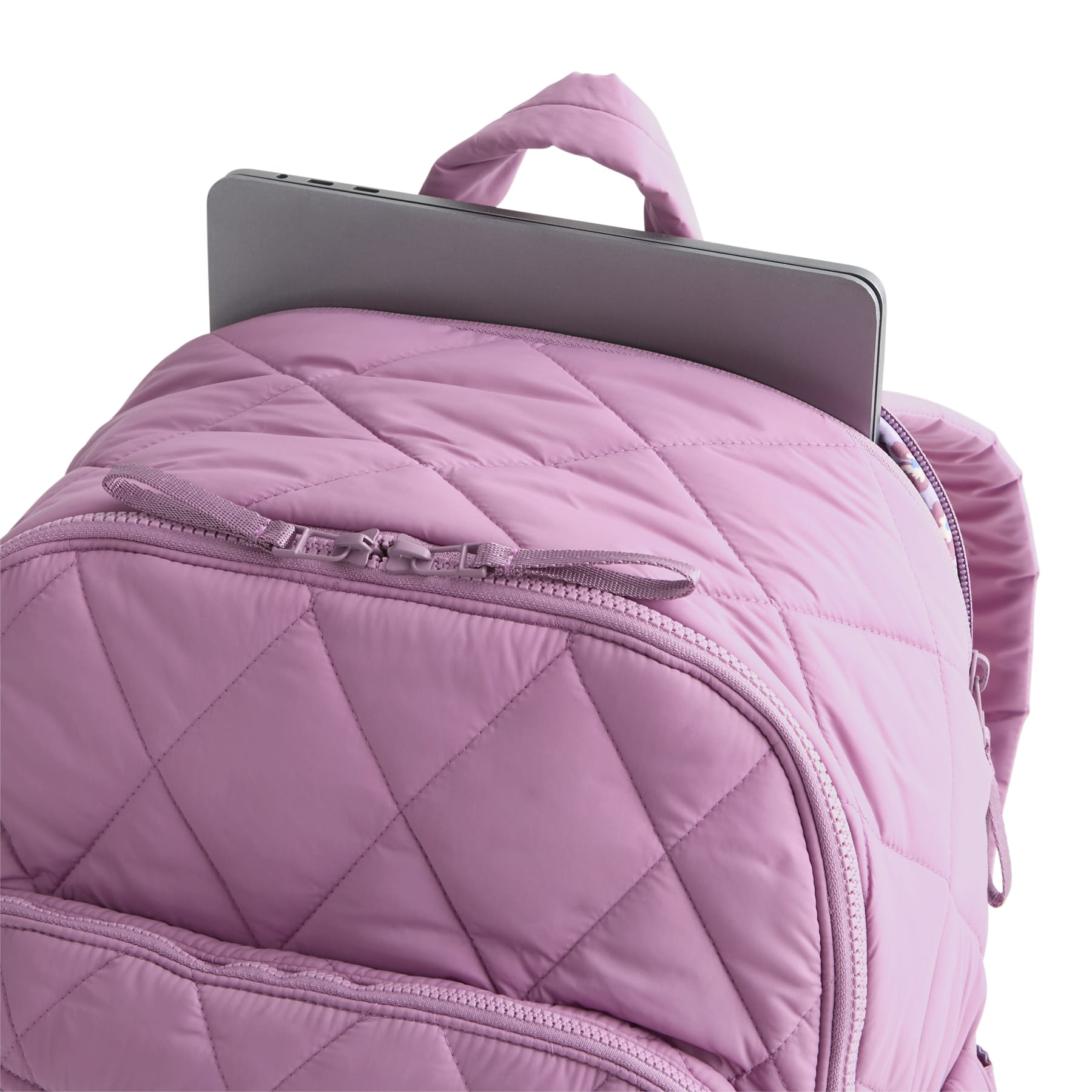 Pink quilted backpack with a tablet on a white background