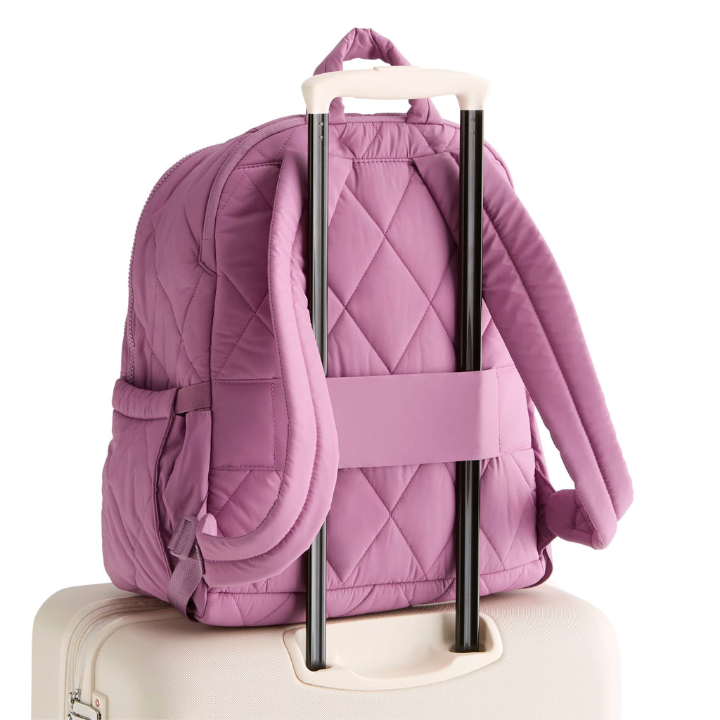 Purple quilted backpack with rolling handle on a white background