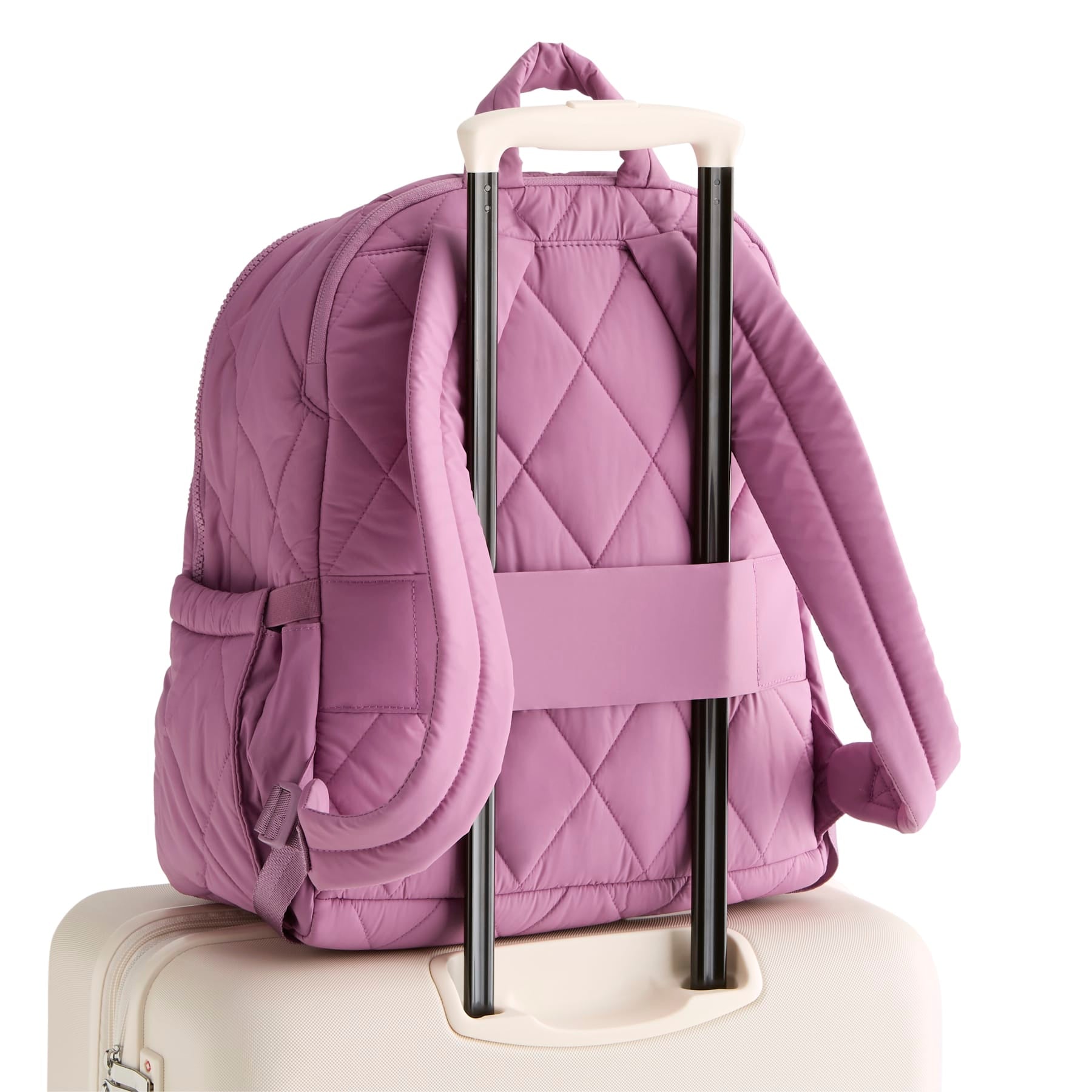Purple quilted backpack with rolling handle on a white background