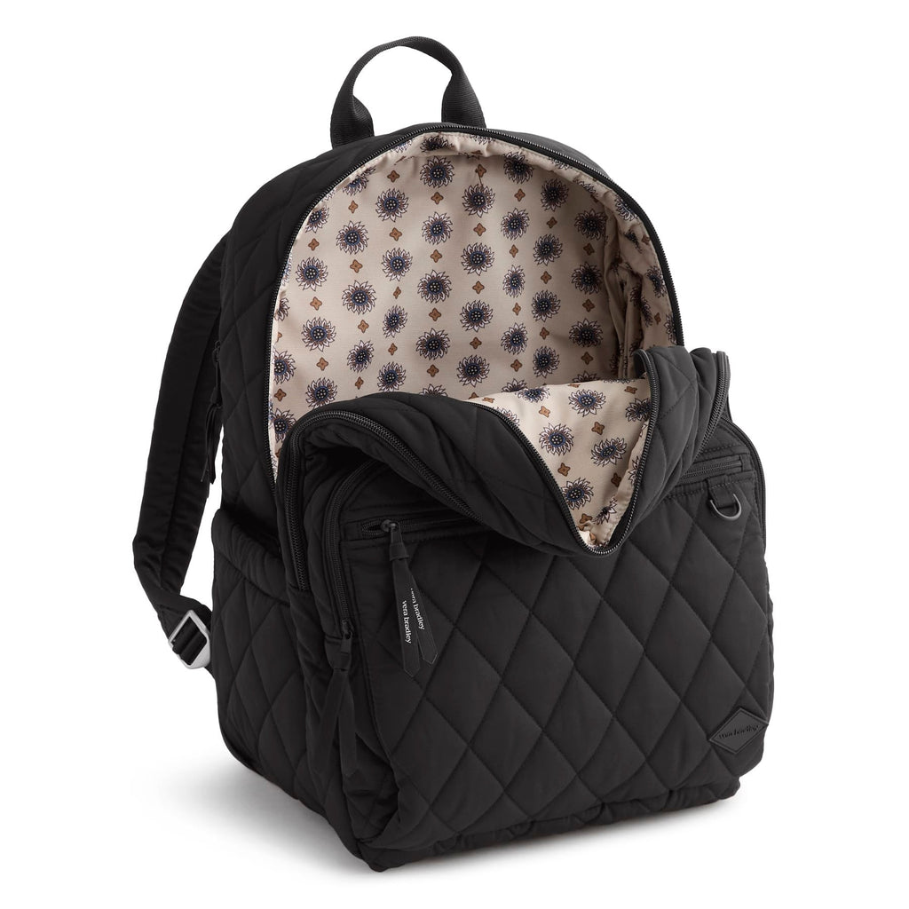 Black quilted backpack with patterned interior on a white background